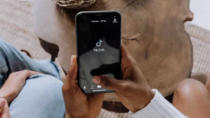 TikTok App opened on a phone held by a person