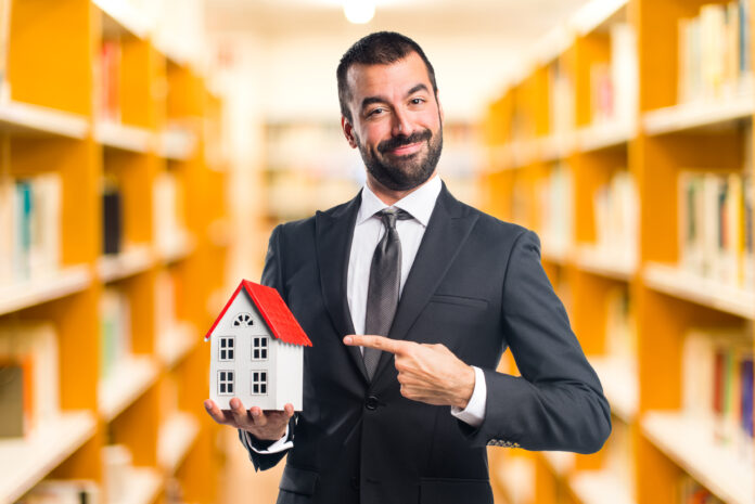 Businessman holding a little house Making Your Property Safer and Better Looking