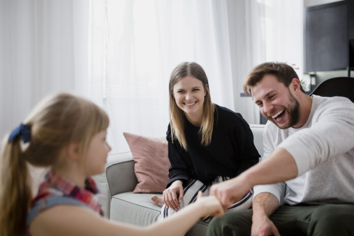 girl-bumping-fists-with-parents Life Insurance for New Ottawa Parents